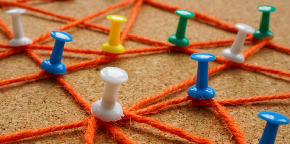 Web from ropes and pins as symbol of connection and communication.